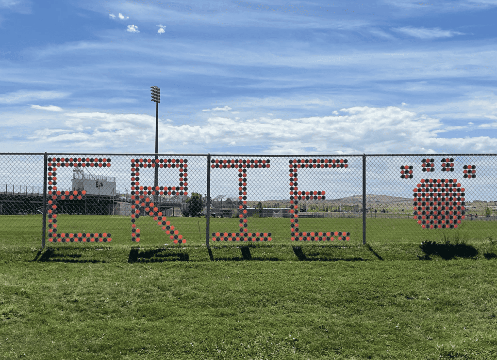 photo of the fence infront of the football stadium with erie tiger decorations