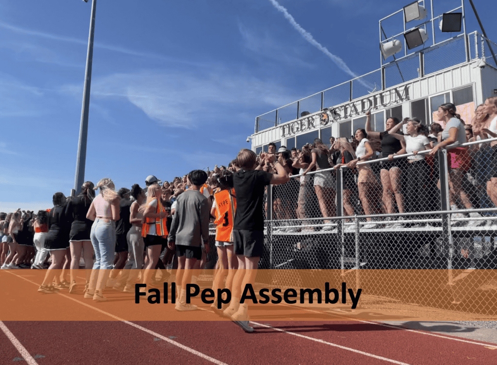 pep assembly students jumping in the grand stands 